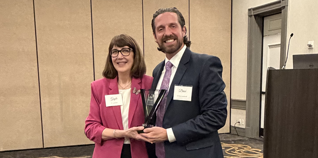 Dr. Gayle Glenn accepting the 2026 DCDS Dentist of the Year Award from Dr. Drew Vanderbrook